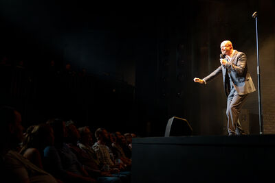 Comedian on stage with microphone