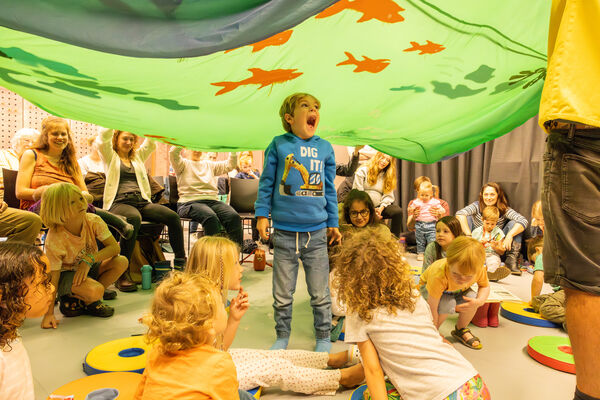 Children under a parachute game 