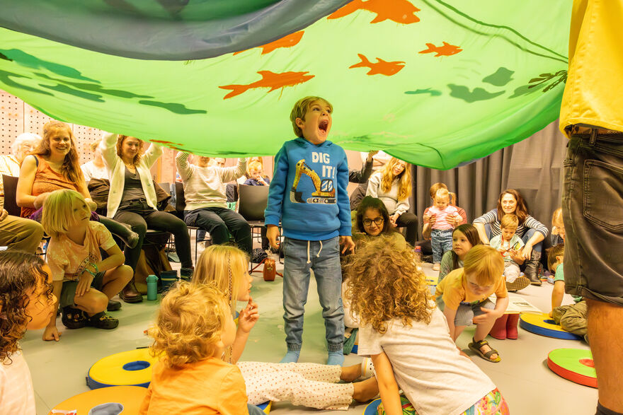 Children under a parachute game