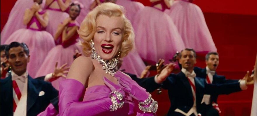 Marilyn Monroe in a pink dress and diamond necklace