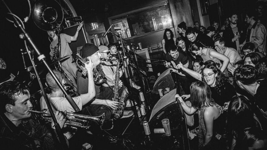 Voodoo Brass Band on stage with a lively audience
