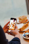 view of phone screen, taking a photo at a food shoot