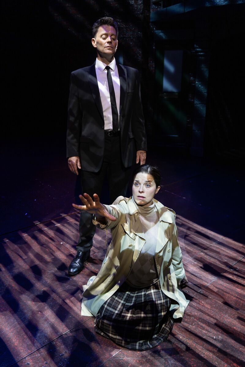 2 cast on stage with female reaching out