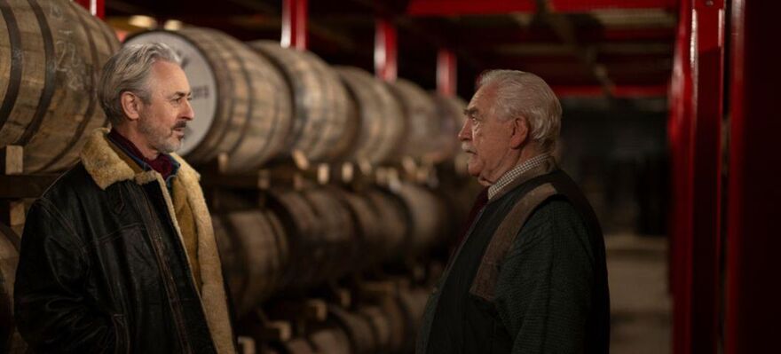 Two brothers standing in the middle of a whisky distillery