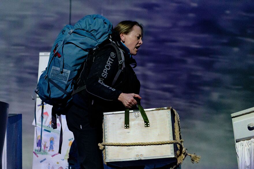 Woman walking across stage in expedition wear