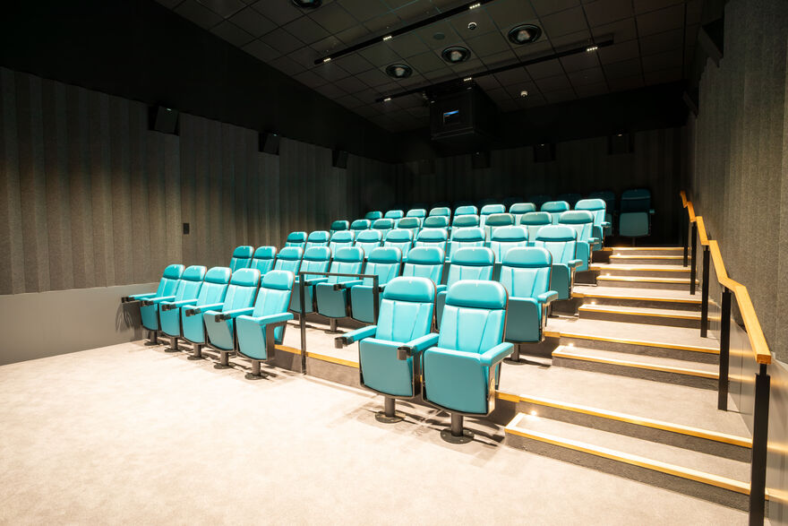 Cinema screen with teal seats