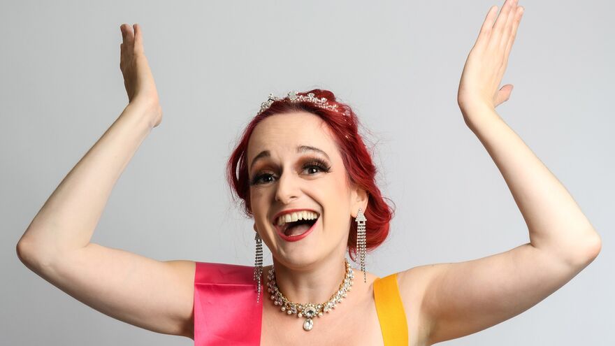 Sooz Kempner posing with a tiara and sash