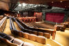 Auditorium with blue seats and brown walls