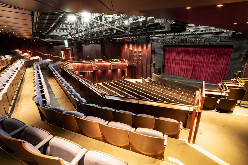 Auditorium with blue seats and brown walls