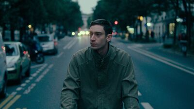 A young man riding a bicycle down the road