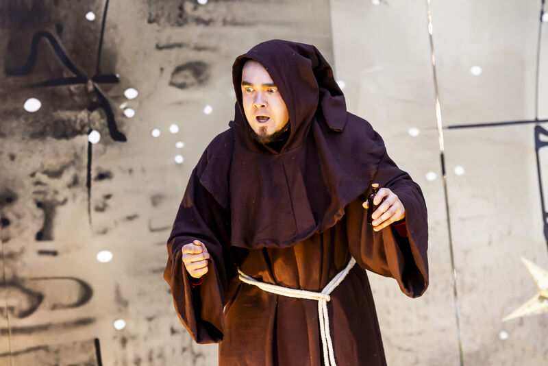 An actor dressed as a friar looks shocked