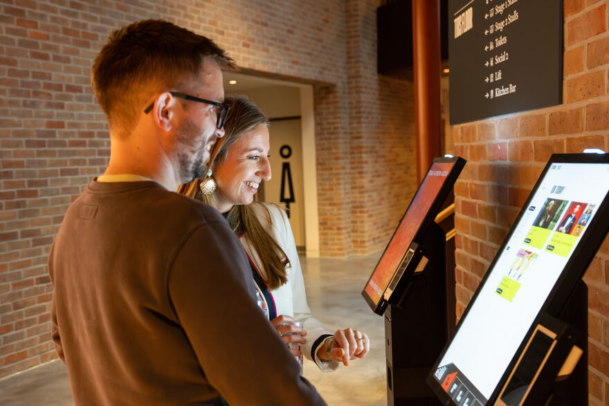 Couple buying tickets on a kiosk