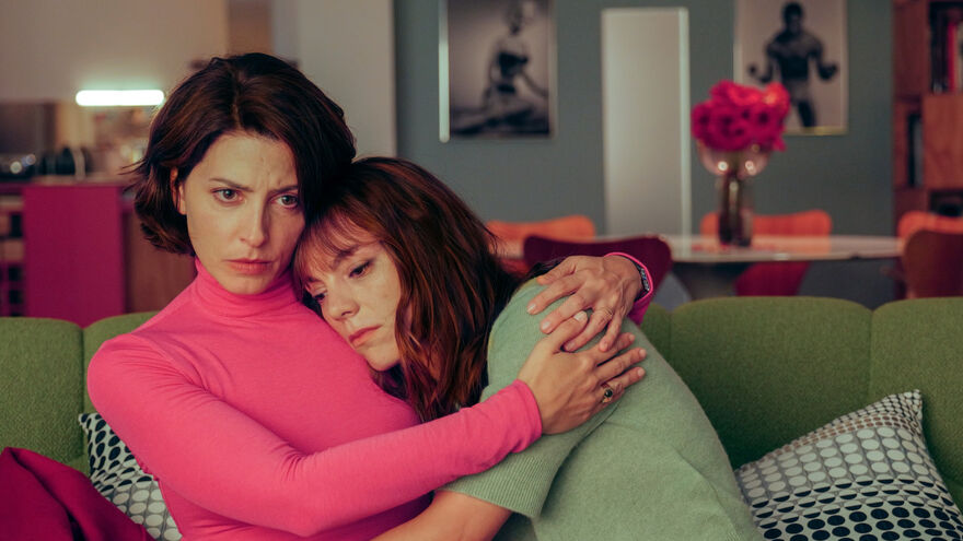 Two women hugging looking sad/concerned