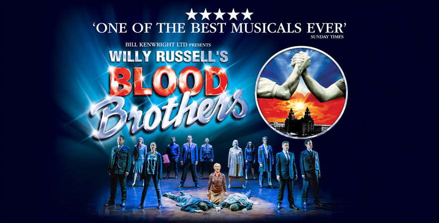 The cast of Blood Brothers on Stage facing forward