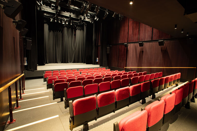 Auditorium with red seats and brown walls