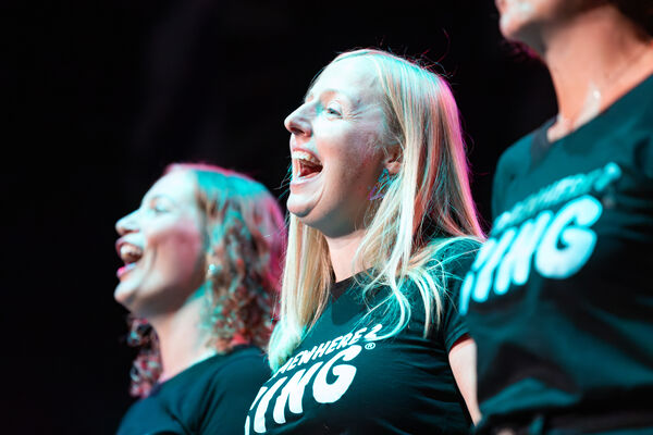 Close up of three females singing.
