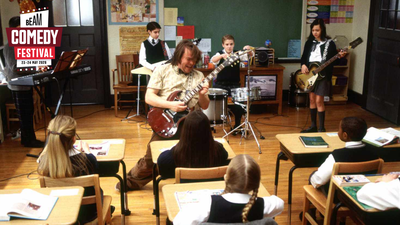 School of Rock - Teacher plays guitar in classroom with students